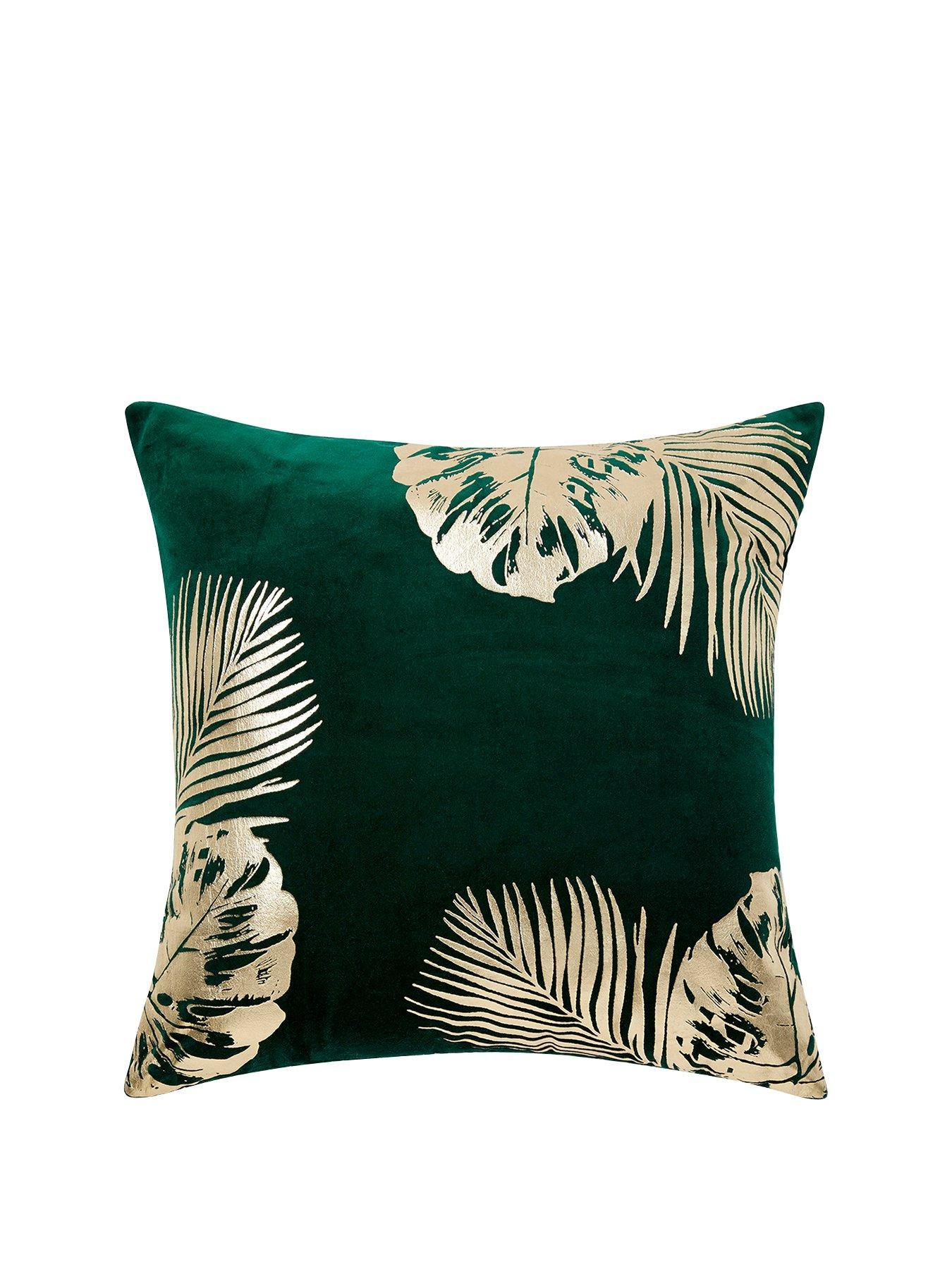 Green and gold leaf print cushion home accessories inspiration| Today we're talking inspiration for adding green to your living room. Green is a really versatile colour to decorate your home with. But, which colours and tones work well? What kind of accessories work with green? This post gives you ideas for pulling together an elegant green colour palette and pieces for your home. Read more: kittyandb.com #greenlivingroom #greenaccessories #greencolorpalette #interiordecoratinginspiration #greenaesthetic #greensofa #cushion #greenandgold