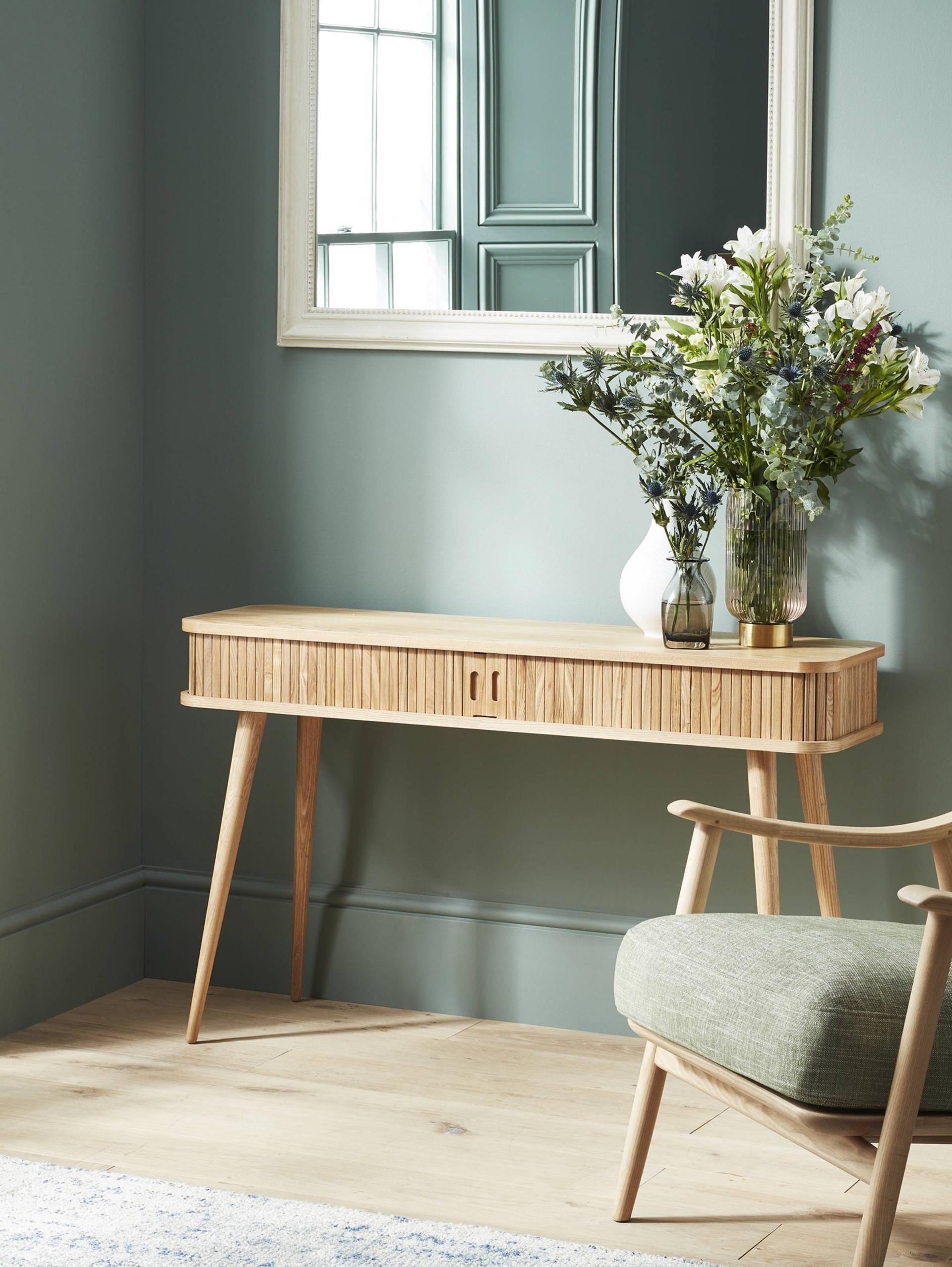 Sage Green Walls with Wooden  Console table| Today we're talking inspiration for a green living room. Green is a really versatile colour to decorate your home with. But, which colours and tones work well? What kind of accessories work with green? This post gives you ideas for pulling together an elegant green colour palette and pieces for your home. Read more: kittyandb.com #colourpalette #sagegreen #colourfulhomedecor #console #greenaesthetic 