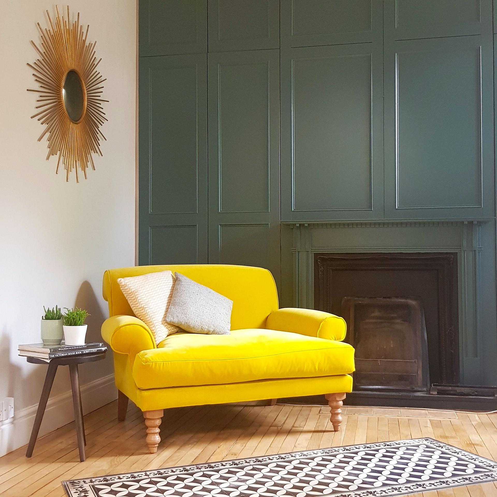 Green Panelled Walls with Yellow Chair | Green Living Room Inspiration| Today we're talking inspiration for a green living room. Green is a really versatile colour to decorate your home with. But, which colours and tones work well? What kind of accessories work with green? This post gives you ideas for pulling together an elegant green colour palette and pieces for your home. Read more: kittyandb.com #greenlivingroom #greencolorpalette #Greenandyellow #greenaesthetic #colourfulhomedecor